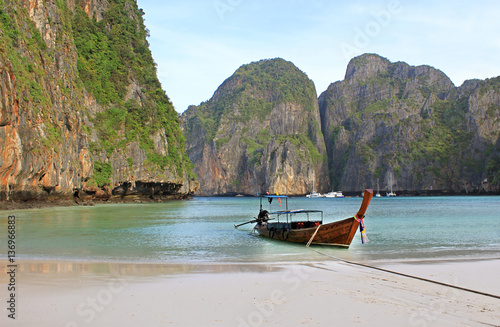 Holiday vacation concept background - Long tail boat on tropical beach with limestone rock, Krabi, Thailand photo