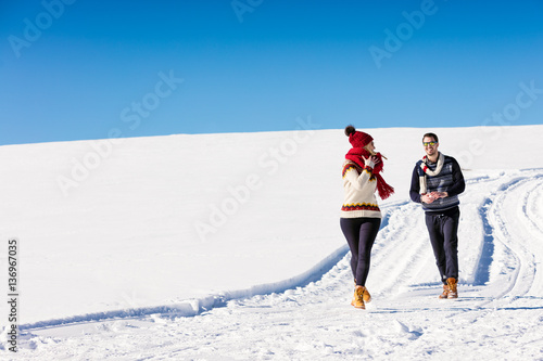 Couple having fun running down slope