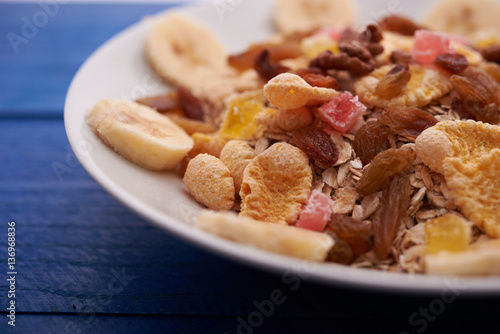 flakes with dried fruit, granola on the plate