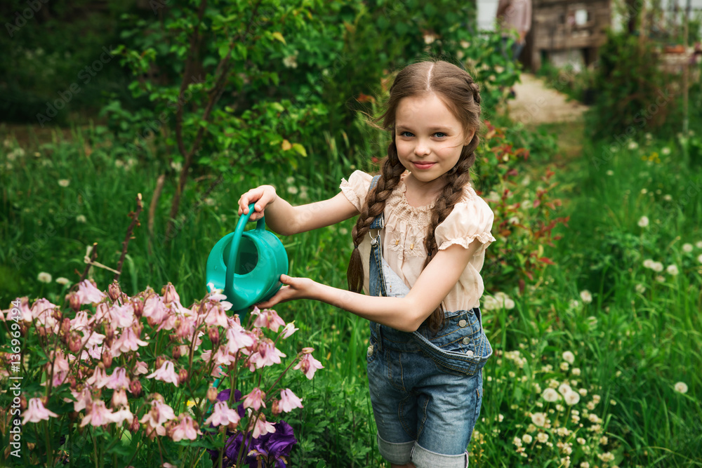 Little cute girl watering trees and flowers Little cute girl watering trees and flowers