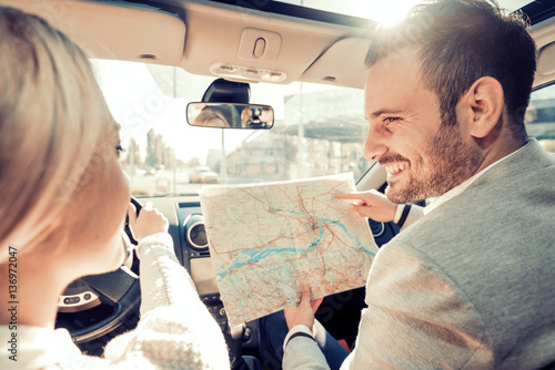 Happy young couple traveling by car on vacation photo