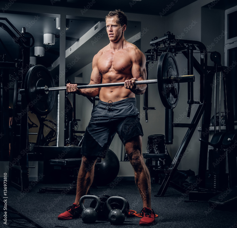 A man doing workouts in a gym. A man doing workouts in a gym.