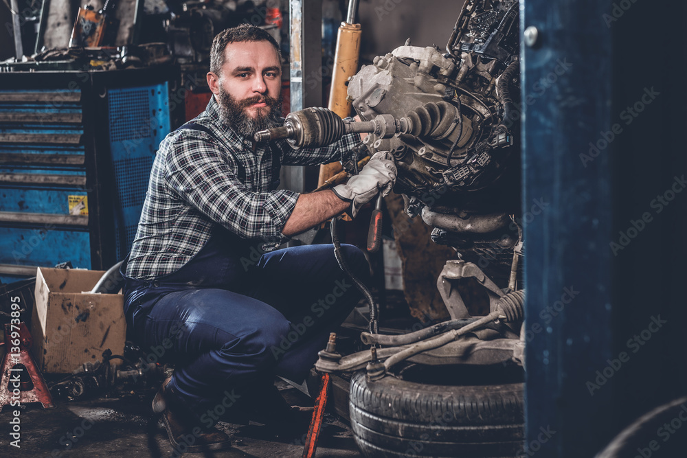 A man repairing the car's engine.