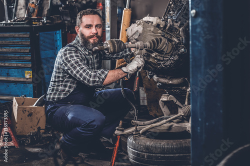 A man repairing the car's engine.