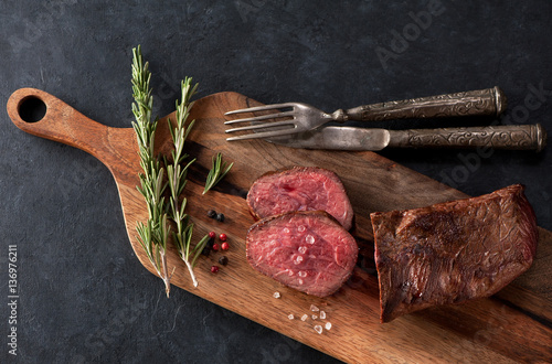 Roast beef on a wooden cutting board