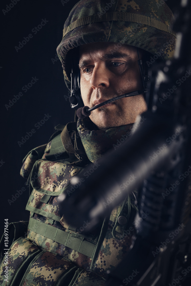 Fototapeta premium Special forces soldier with rifle on dark background