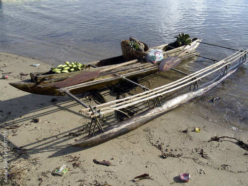 An outrigger canoe on the beach in Esa'ala on the north coast of Normanby Island in the d'Entrecasteaux group of Milne Bay Province..Papua New Guinea.17/12/2005 photo