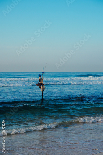 Local fisherman on stick on a beach of Indian ocean, Sri Lanka