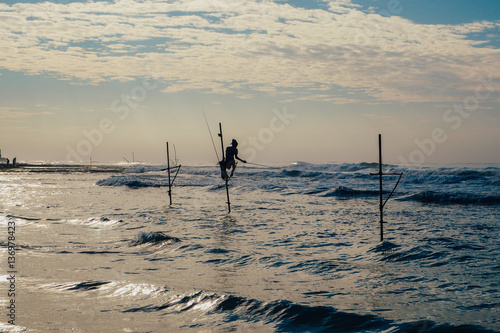 Local fisherman on stick on a beach of Indian ocean, Sri Lanka