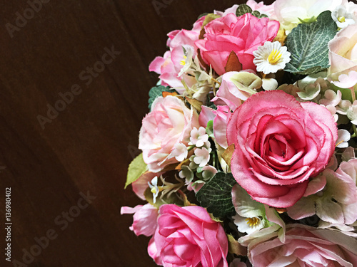 Bouquet of pink roses fake on a wooden table © phatthanit
