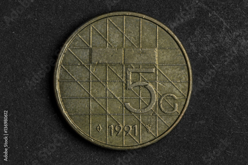 Close up of 5 beatrix koningn der nederlanden coin on black background - business concept