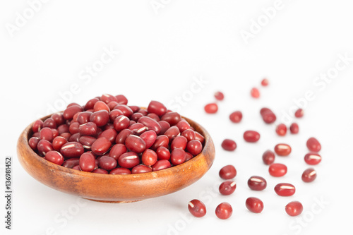 Red azuki beans in wooden bowl on white background. Vegan vegetarian healthy food.