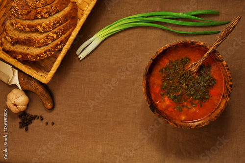 Vegeterian dinner contains of soup, bread, fresh onion and garli photo