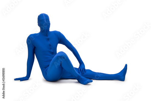 Mysterious blue man in morphsuit lying on the floor