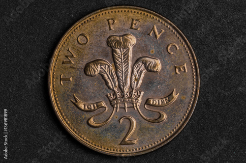 Billede på lærred Close up of 2 two pence coin on black background - business concept