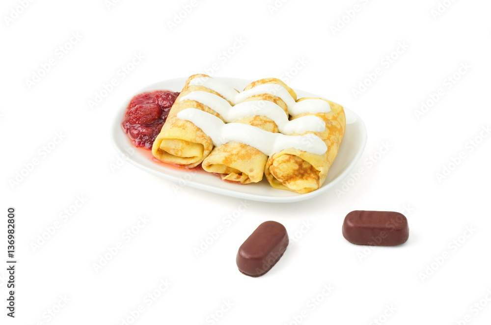 pancakes with sour cream, jam, chocolate candy, on a white background pancakes with sour cream, jam, chocolate candy, on a white background