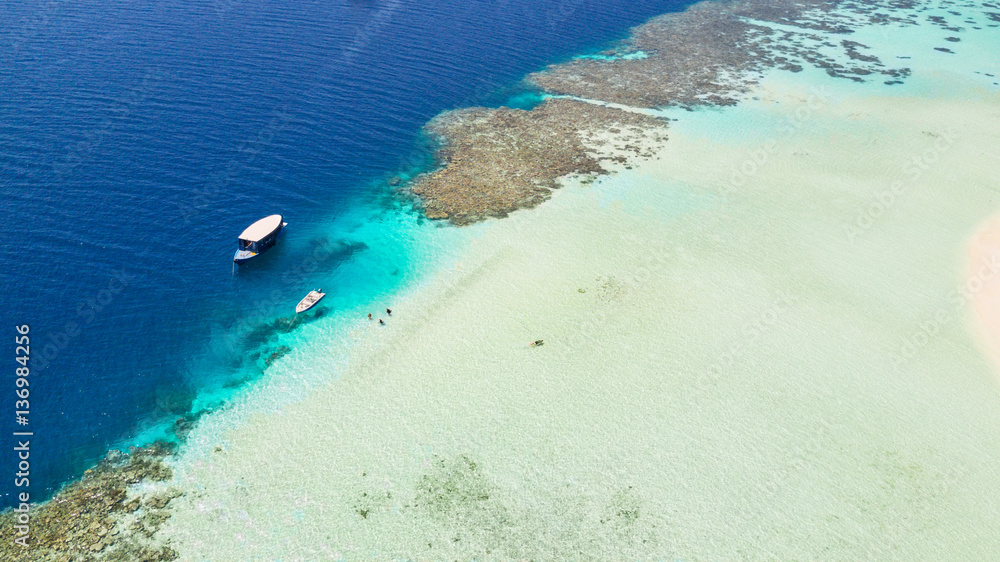 Beautiful coral reef with anchoring boats Beautiful coral reef with anchoring boats