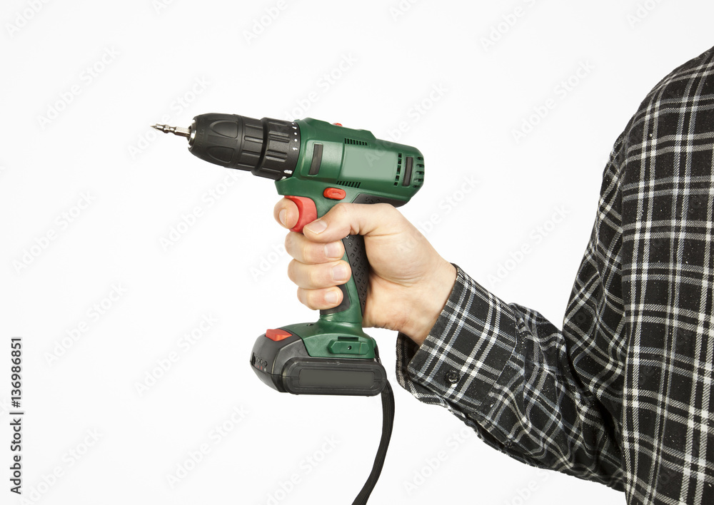 Drill in man's hand on white background