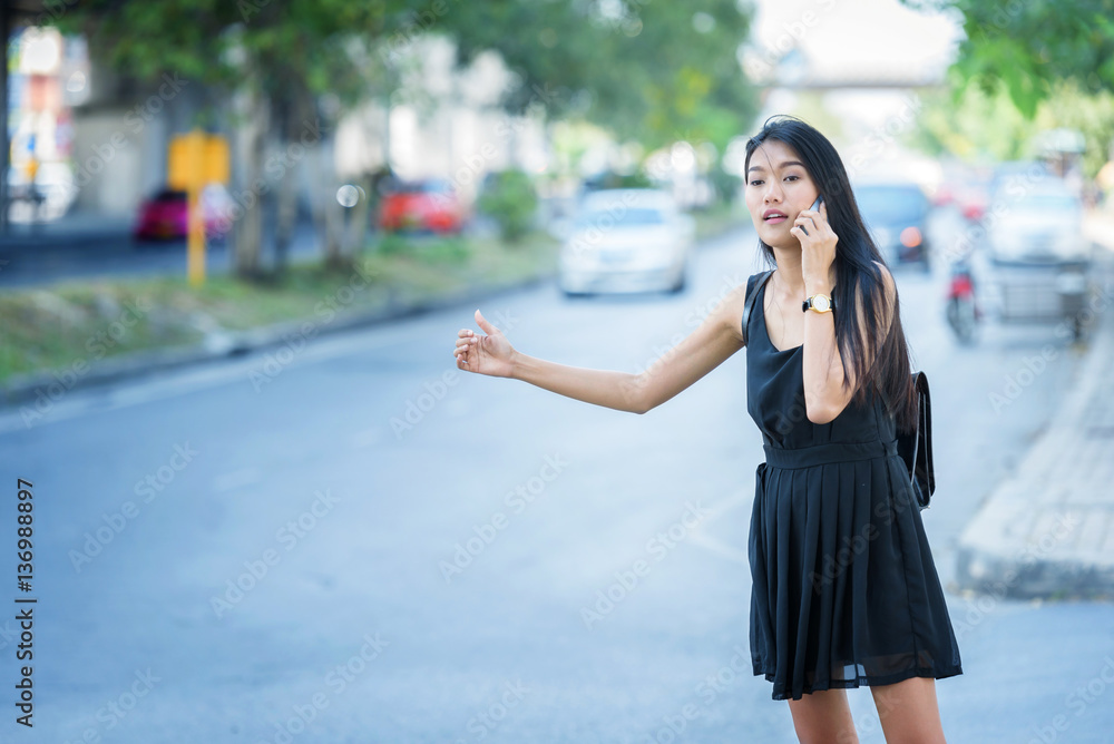 woman hand on mobile phone and wearing dress black walking on st woman hand on mobile phone and wearing dress black walking on st