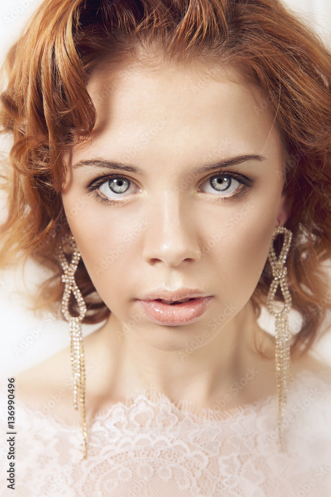 Portraits of a young bride on light background