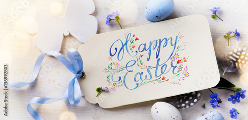Easter card  Easter eggs and spring flovers on wood background © Konstiantyn