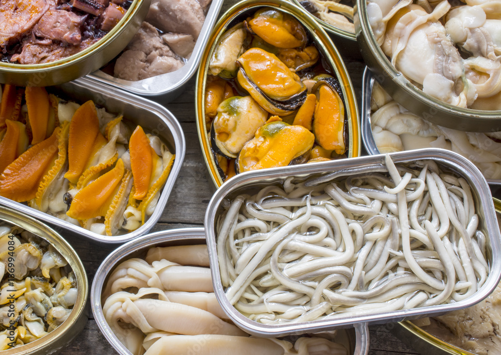 Assortment of cans of canned with different types of fish and seafood ...