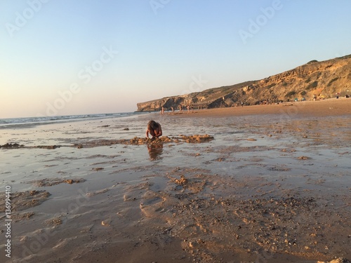 CHILDREN PLAYING AT SEASIDE photo