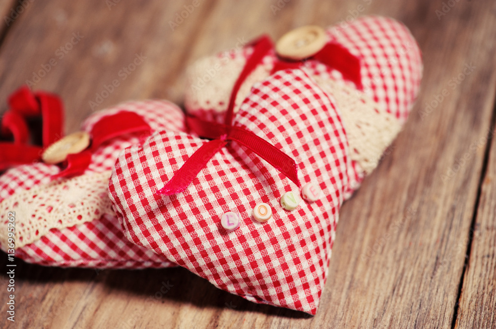 Hearts made of cloth on a wooden background Hearts made of cloth on a wooden background