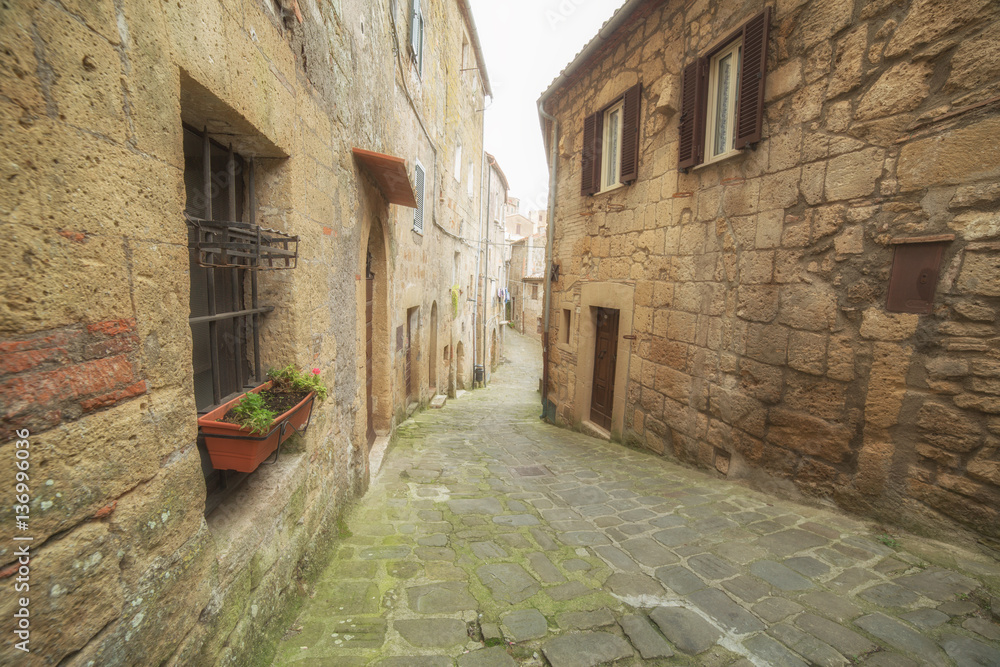 Narrow street of medieval town in Italy