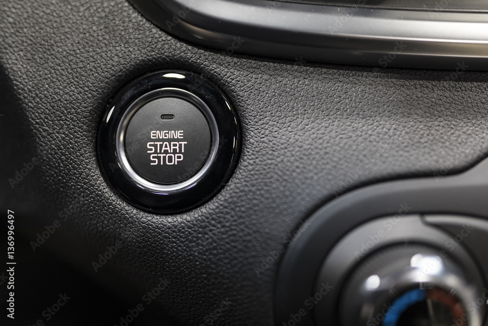 Car dashboard with focus on engine start stop button