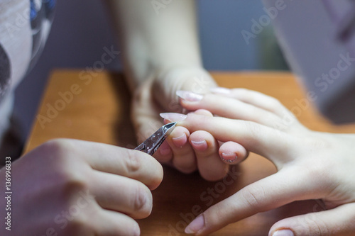 Closeup Of Woman Hands Receiving Nail Care Treatment By Professi
