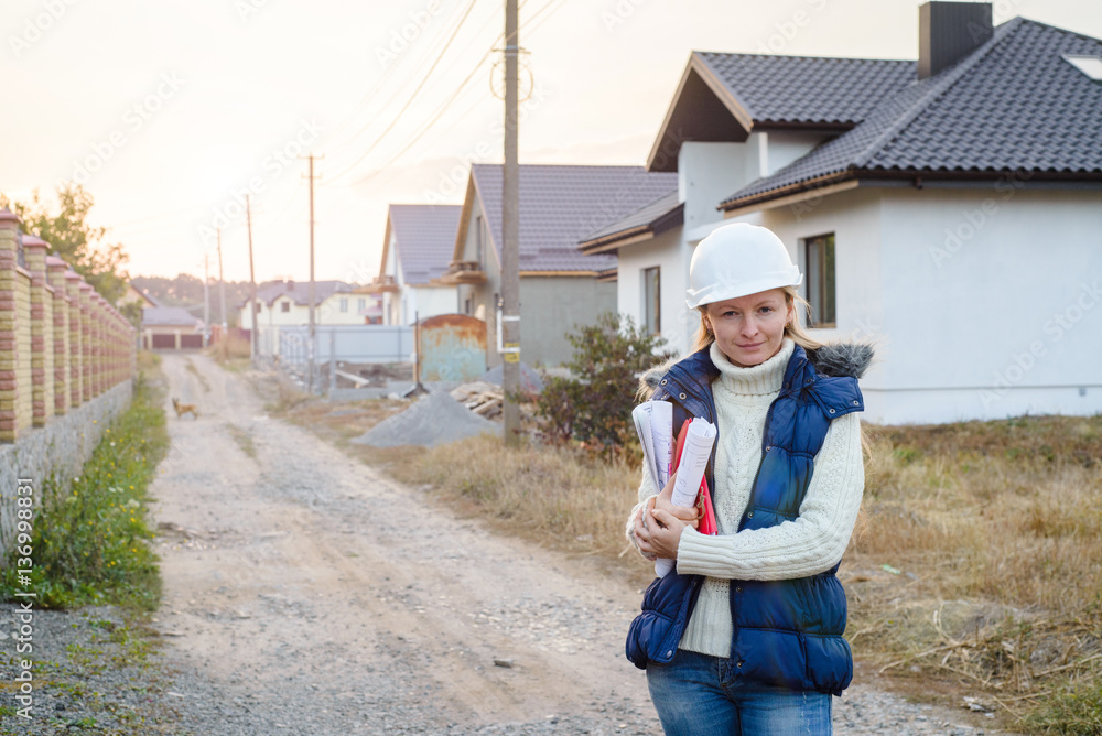 Female architect at a construction site looking busy