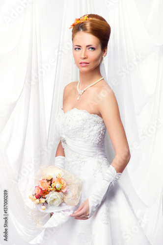 Young, beautiful and emotional bride with a beautiful flowers