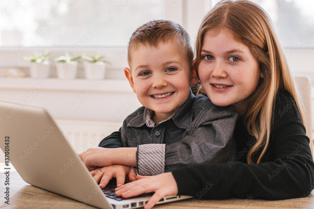 Children with laptop at home Children with laptop at home