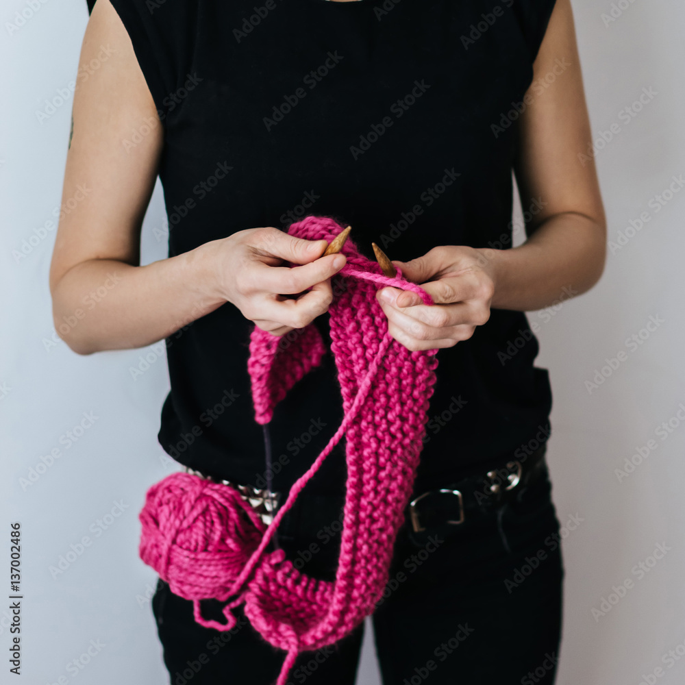 Punk girl knitting with pink wool