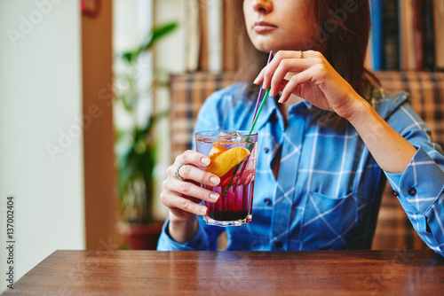 Woman drinking lemonade in cafe restaurant