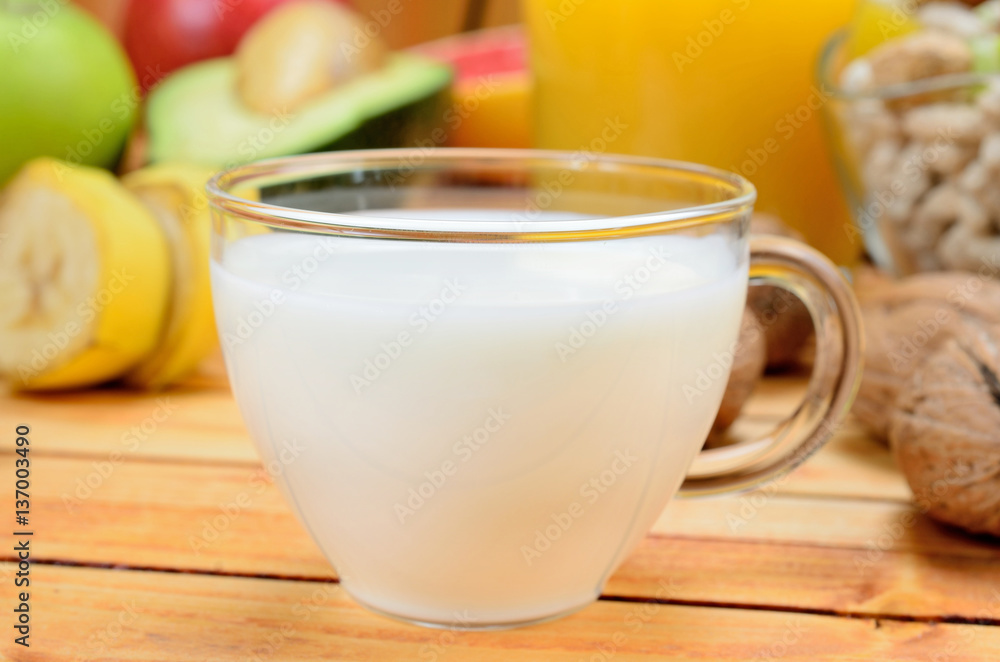 cup of milk with fruit on table
