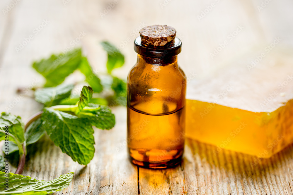 organic cosmetics with herbal extracts of mint on wooden background organic cosmetics with herbal extracts of mint on wooden background