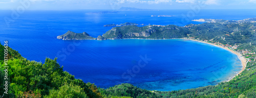 Beautiful summertime panoramic seascape. View of the cliff into the crystal clear azure sea bay and distant islands. Agios Stefanos cape. Afionas. Corfu. Greece.