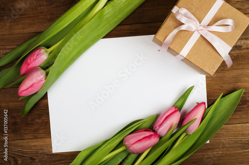 Fototapeta Naklejka Na Ścianę i Meble -  Pink tulips and white paper. Mother's Day. Spring flowers