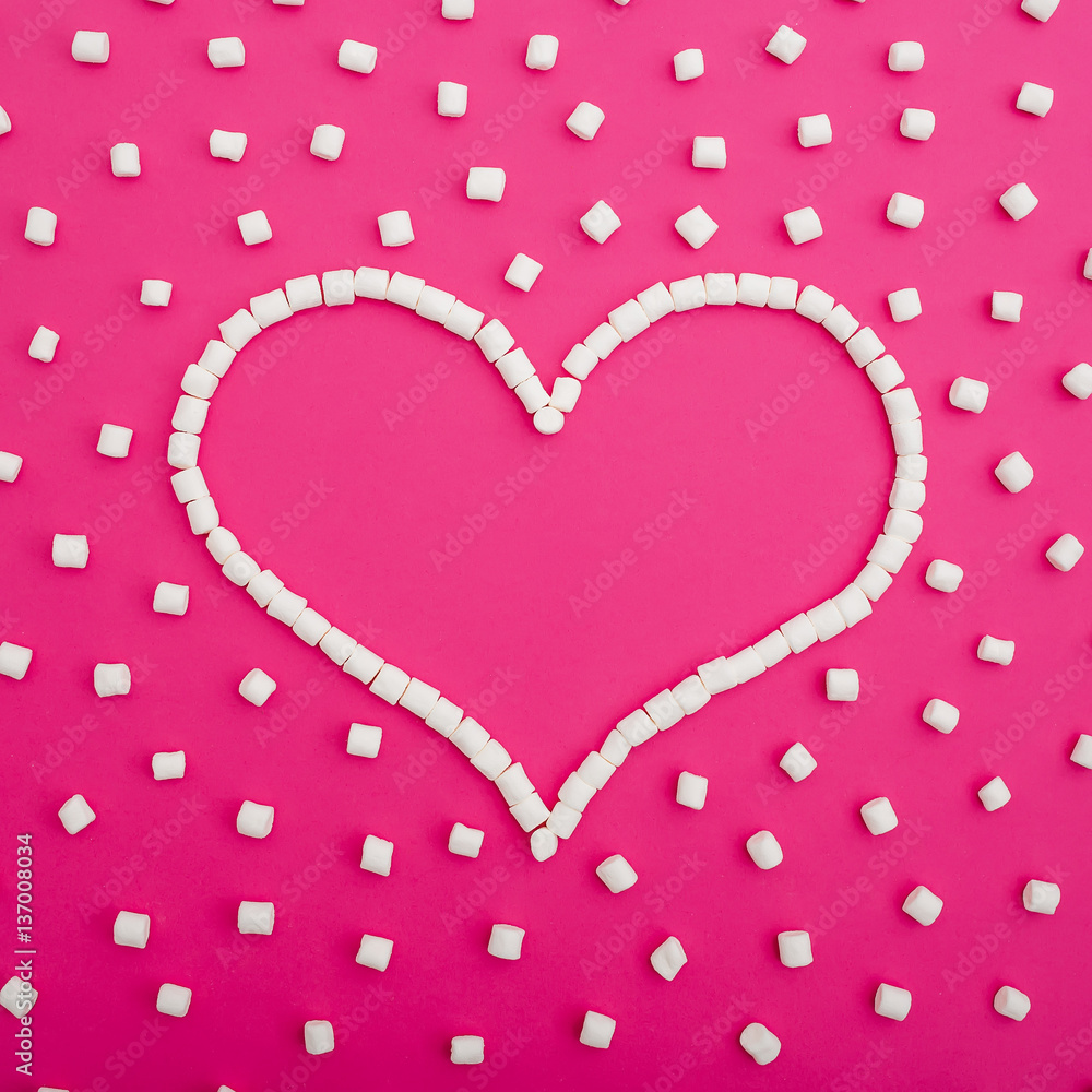 Marshmallows isolated on pink background. Flat lay. Top view. Love background