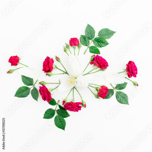 Floral background. Floral pattern made red roses  tulip petals and branches on white background. Flat lay  top view.