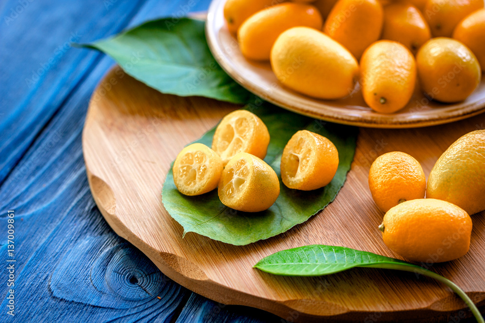 kumquat on plate at wooden table kumquat on plate at wooden table