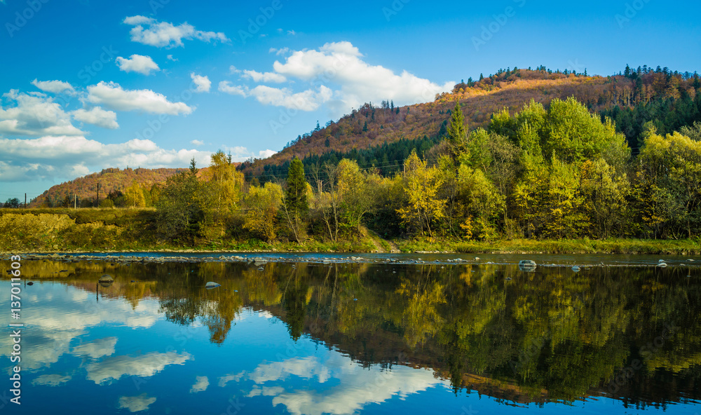 Autumn forest and sky and mountains and river Autumn forest and sky and mountains and river