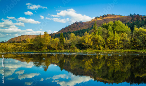 Autumn forest and sky and mountains and river