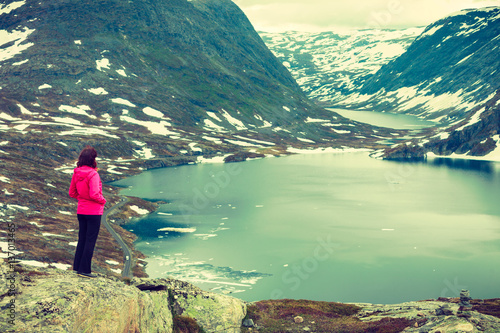 Tourist woman standing by Djupvatnet lake, Norway