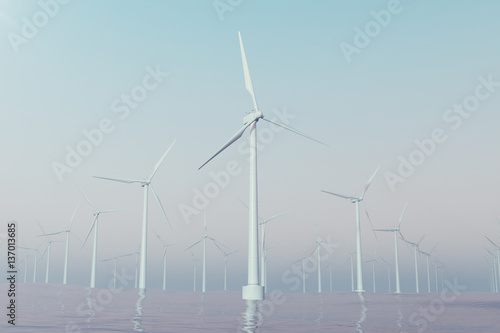 Offshore wind farm turbines caught in sunset sky. Beautiful contrast with the blue sea. ecological concept. 3d rendering