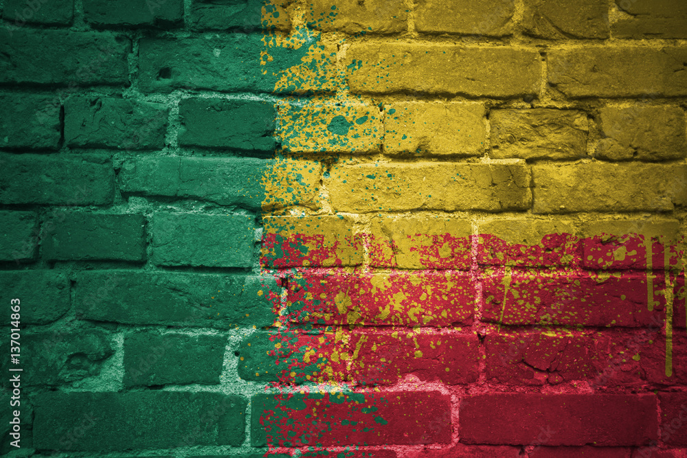 Fototapeta premium painted national flag of benin on a brick wall