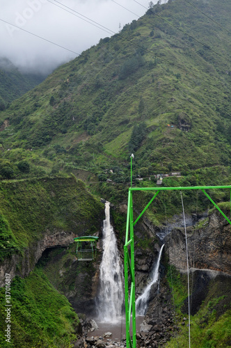 zipline adventure against Manto de la Novia waterfall in Banos de Agua Santa, Tungurahua, Ecuador photo