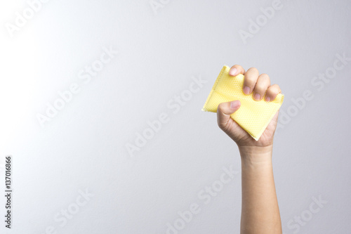 Hand holding a cleaning sponge